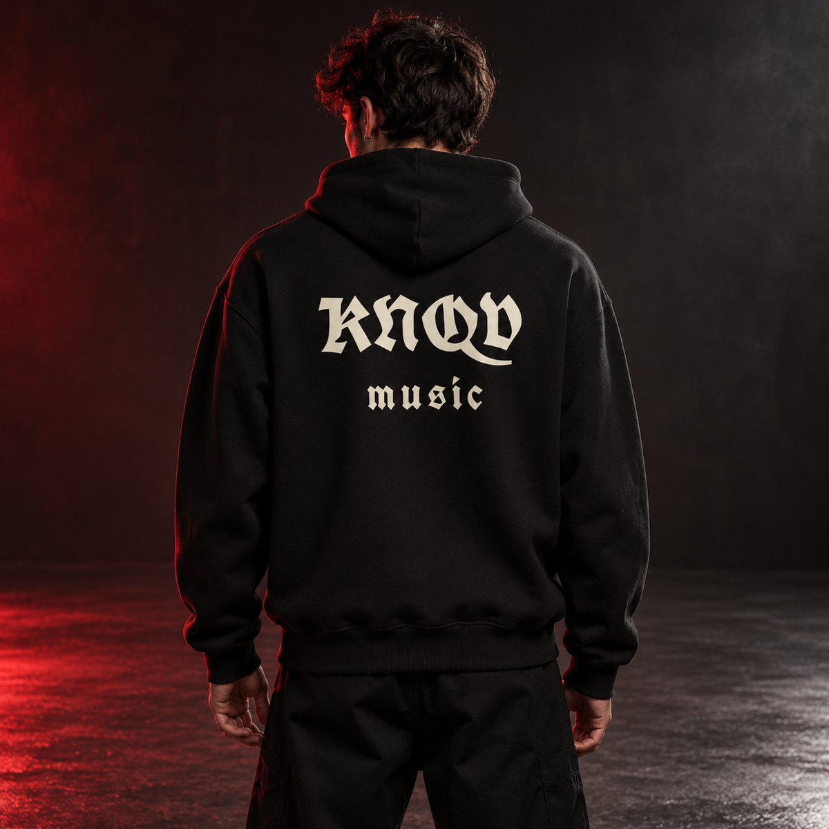 KNQV Music Capsule hoodie — AI-generated red-studio model-back mockup