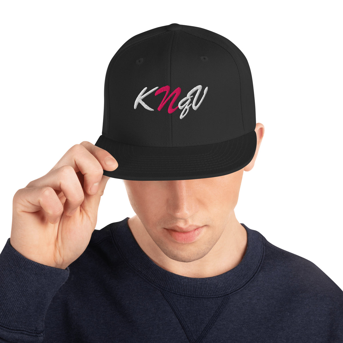 Male model wearing KNQV Hot Signal black and pink embroidered snapback — Printful digital mockup